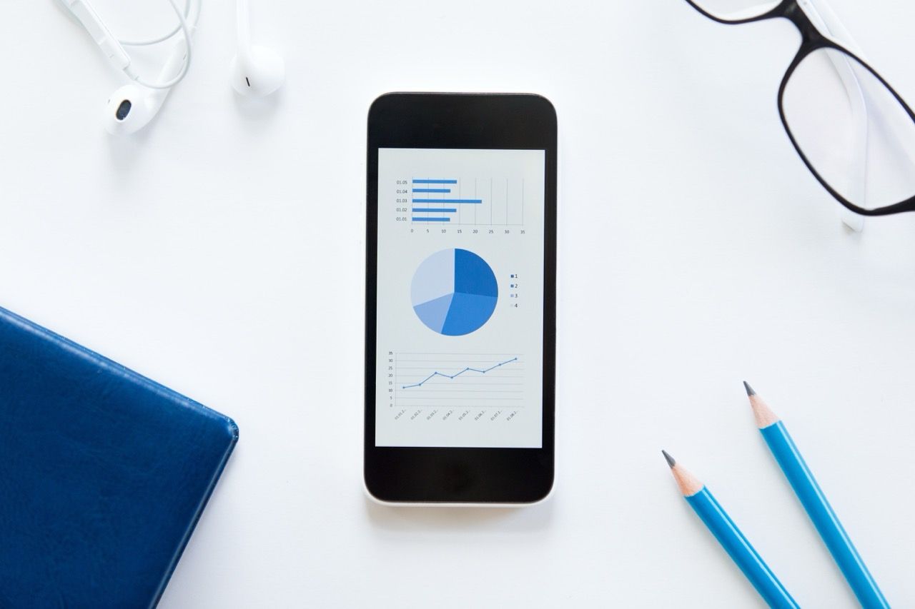 white_desk_with_glasses_phone_with_diagram_earphones_min_e4eed984a0 Large.jpeg